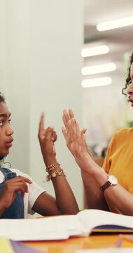 Girl, teacher and student with mathematics in library for education, counting or number lesson. Educator, tutor or teaching learner with fingers for learning, addition or subtraction in school