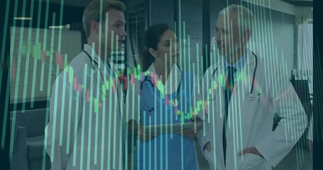 Analyzing medical professionals viewing digital charts in hospital corridor with tablet stethoscope
