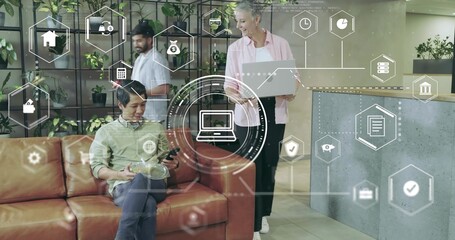 Checking smartphone tablet amid holographic icons, man sitting on sofa in office lounge copy space