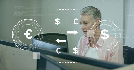 Analyzing analyst in pink top examining monitor with euro to dollar graphics at cubicle, copy space