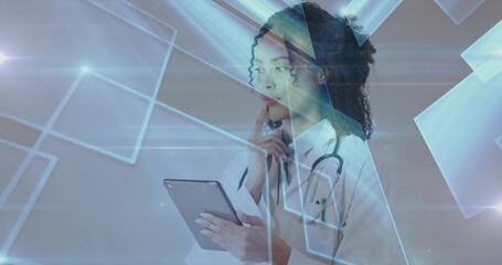 Reviewing tablet resting chin doctor in lab coat studying digital interface in lab with stethoscope