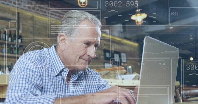 Typing senior man in checkered shirt using silver laptop at coffee shop, with floating digital data