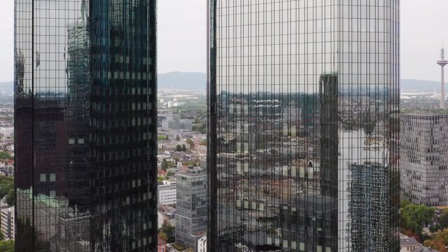 Parallel aerial flyby along the skyscrapers in Frankfurt, symbolizing the strength, stability, and interconnectedness of the European financial system in a major economic hub.