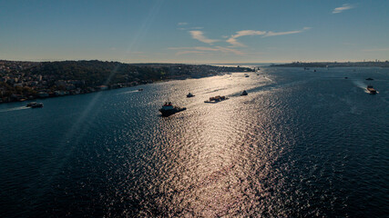 Aerial view of the Bosphorus Bridge with drone on a cloudy day. Tanker ship passing under the FSM Bridge with a heavy car traffic on the bridge.Aerial view of The Second Bosphorus Bridge.