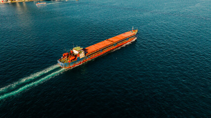 Aerial view of the Bosphorus Bridge with drone on a cloudy day. Tanker ship passing under the FSM Bridge with a heavy car traffic on the bridge.Aerial view of The Second Bosphorus Bridge.