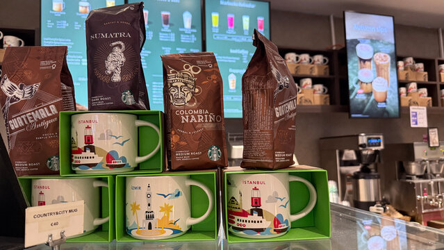 Istanbul, Turkey - October 18, 2025: Starbucks coffee mugs and bags on display in cafe with vibrant branding elements