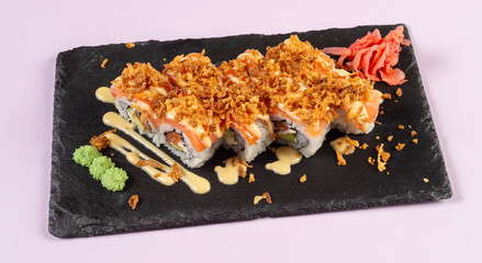 Gourmet salmon sushi rolls served on a black plate with garnishes, ready for a fine dining experience