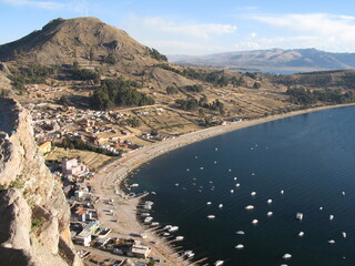 Aerial view of Copacabana on the shores of Lake Titicaca, Bolivia, surrounded by Andean mountains...