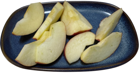 Fresh apple slices neatly arranged on a blue plate