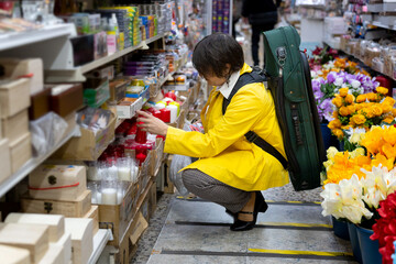 Woman shopping in store carrying violin case