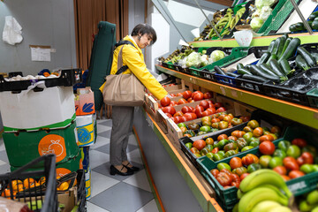 Violin teacher buying fresh vegetables at local market