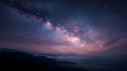 Naklejka premium Majestic Milky Way galaxy stretches across a twilight sky above misty mountains