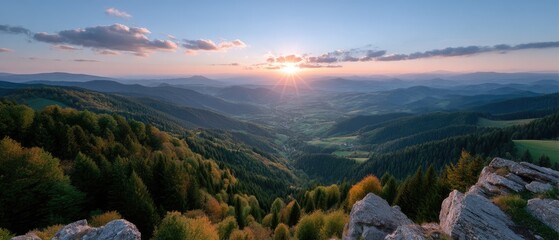 Golden Sunset Over Lush Green Rolling Hills and Forests Viewed From Rocky Outcrop in the Evening