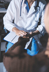 A female nurse caregiver holds hands to encourage and comfort an elderly woman. For care and trust in nursing homes for people of retirement age Caregiver helping elderly woman provides medical advice