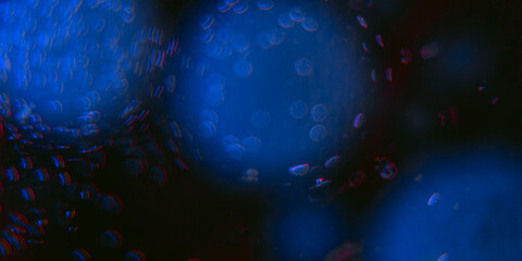 Extreme macro close-up of dark liquid with circular clusters of tiny blue bubbles, contrasting strongly with a dark red or deep purple background.
