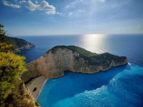 Navagio, Zanakinf ,Greece - September, 19, 2025: Aerial view of a rocky coastline with steep cliffs and clear blue waters