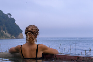 Relaxing in a serene hot spring overlooking the tranquil waters of Russia