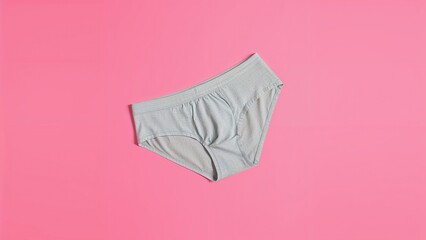 Gray underwear on pink background. Clothing and fashion, underwear, minimalism. Comfort and daily wear essentials. The concept of wardrobe basics and apparel.