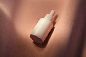 Bottles of facial serum in the soft sunset light.