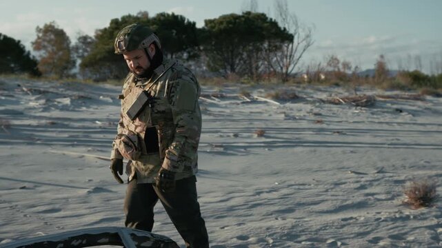 Mercenary Soldier Looking At A Car Wreck Destroyed By A Bomb 