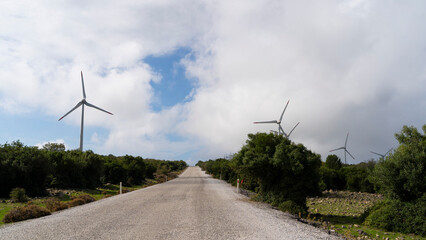 Rural Gravel Road Leading to Wind Turbines