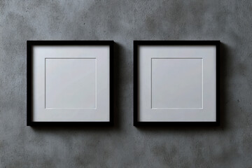 Two square black picture frames hanging on a textured gray wall, creating a minimalist and modern aesthetic