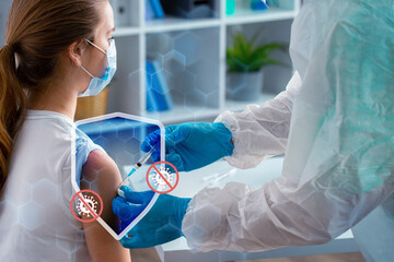 Health worker administers vaccine to young girl in medical setting