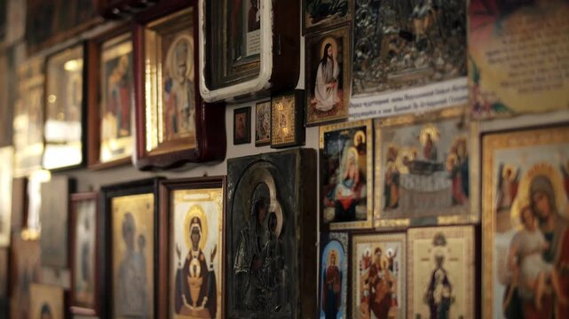 Wall with framed religious icons in traditional art workshop