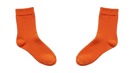 Two orange, ribbed socks positioned on a black background, facing each other