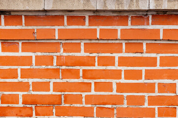 Orange brick wall with white mortar texture. Close-up view of classic masonry pattern for architectural, construction, and background design concepts.