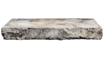 Weathered concrete shelf shows cracks and peeling surface revealing signs of age and wear in a natural setting