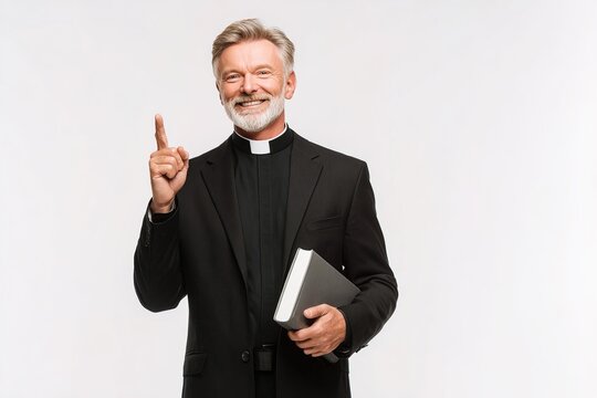 Catholic priest holding Bible and pointing upward with smile, isolated on white background, reflecting guidance, devotion, positive spiritual values. Perfect for education, faith related communication