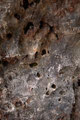 eroded rocky surface, erosion has created textured mineral surface with holes and deep crevices for study
