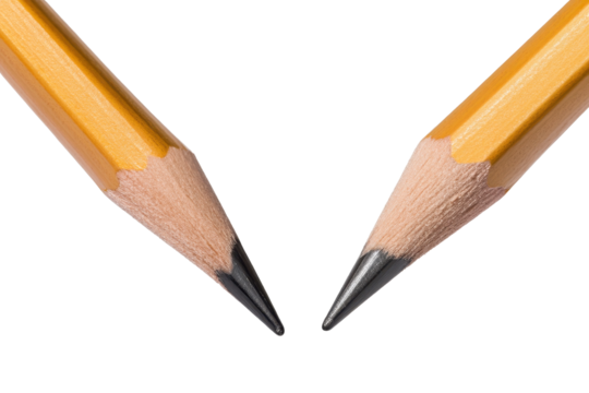 Two pencils positioned to face each other with sharpened tips on a light background showcasing their detailed textures and colors
