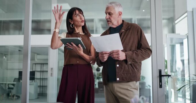 Business people, tablet or documents in office for conversation, timesheet verification or HR admin. Mature man, woman and discussion in meeting with tech, paperwork and review for management report.