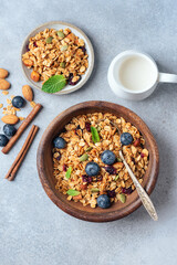 Bowl of Tasty homemade granola with dried fruit, pumpkin seeds and blueberries, top view