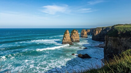 Coastline with sea stacks, cliffs, and ocean waves under a blue sky.