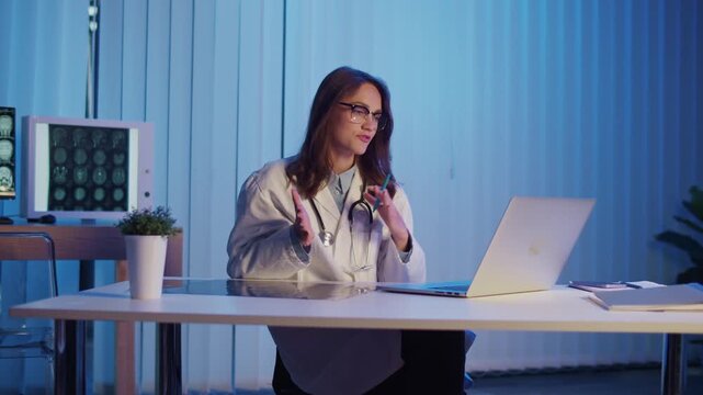Neurology Consultation. Professional Female Doctor in White Coat Reviews Brain Scans During Evening Online Meeting Providing Expert Analysis