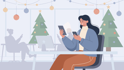 Happy woman using tablet and phone in a modern office decorated for Christmas holidays