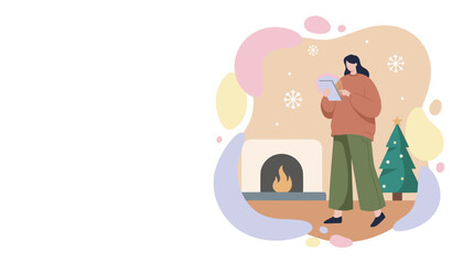 Woman uses tablet near a Christmas tree and fireplace in a cozy winter setting Holiday shopping online