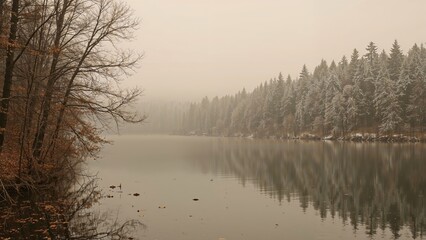 A serene river scene with trees lining the bank and a misty atmosphere. Quiet nature landscape with water reflections and autumn foliage.