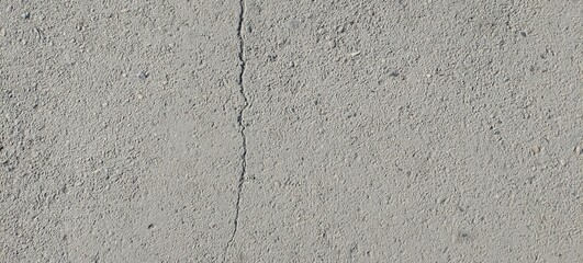 Close-up of asphalt texture with small stones and rough surface. Perfect background for design, construction, road maintenance, or urban concept projects.