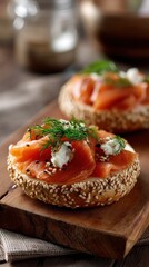 Sesame bagel with lox and dill on wooden plank