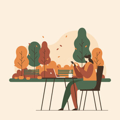 Digital nomad working in an autumn park with phone laptop and coffee