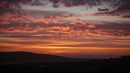 Colorful sunset sky with clouds over a landscape. Nature and sky scene. The concept of evening and atmospheric conditions.