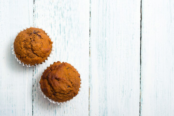 pair of chocolate muffins on white table