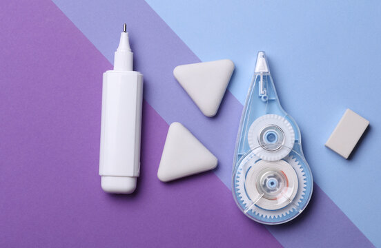 Correctors and erasers on a purple background. Stationery school supplies