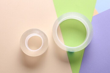 Rolls of transparent adhesive tape scotch on a colored background