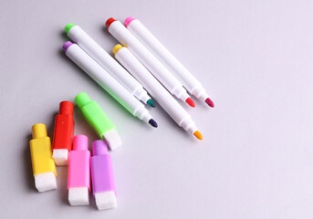 Set of colored markers on a gray background