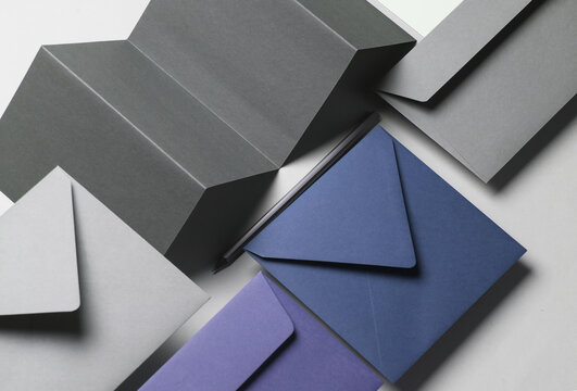 Floating envelopes and brochure, cards on gray background with shadow. Minimalism, modern business still life, creative layout - Powered by Adobe